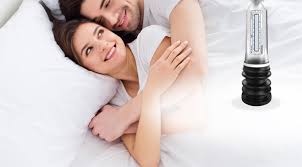 A couple in bed, one holding a penile pump. The image may relate to the topic of sexual decline and the use of penile pumps.