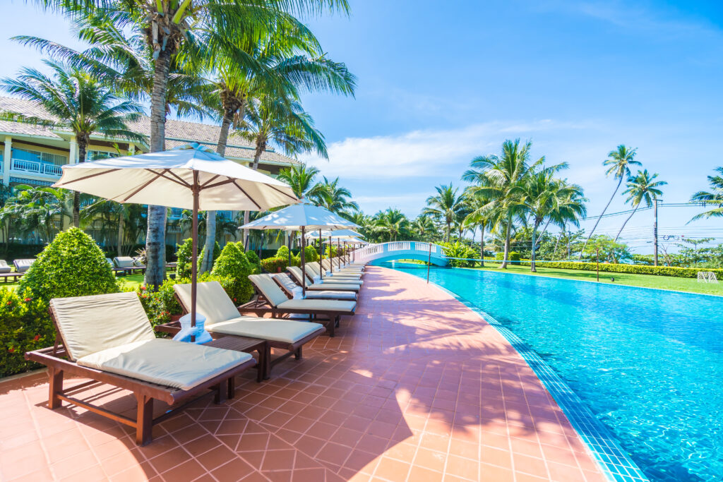 Umbrella and chair around swimming pool