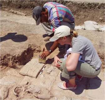 Consulting archaeologist conducting a site assessment, surrounded by historical artifacts and excavation tools, highlighting the intersection of cultural heritage preservation and modern development."